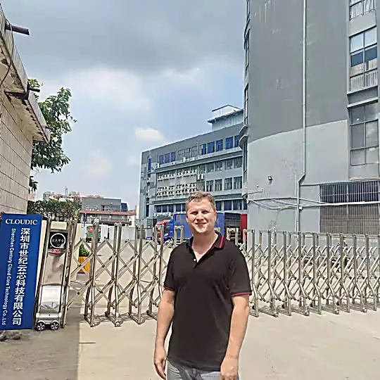 Josip in front of the entrance to a Chinese factory during a visit and supplier verification in the importing process